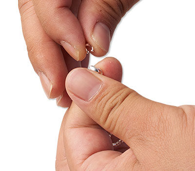 Hands holding an ice pick bail